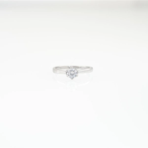 Classic round moissanite ring with six-prong silver setting on white background