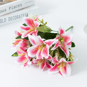 Artificial pink and white lily bouquet with blooming flowers and green leaves
