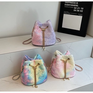 Detail of plush bucket bag with tie-dye faux fur, sequins, chain strap and pearl charms