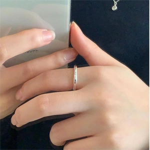 Minimalist 925 sterling silver smiley face ring shown on finger in lifestyle selfie