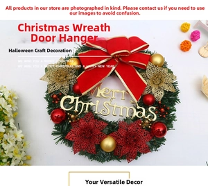Detailed view of a Christmas wreath with red gold bow and Merry Christmas sign