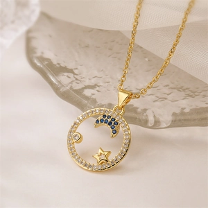 Detailed close-up of a gold-plated moon and star necklace with sparkling zircon inlays