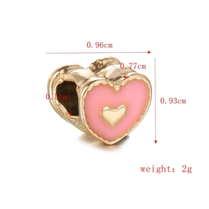 Macro detail of pink enamel heart bead with dimensions 0.96cm x 0.93cm for DIY bracelets