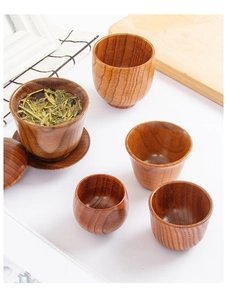 Macro detail of natural wood grain tea set with gaiwan and four matching cups on a table