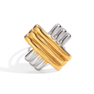 Detail shot of a two-tone gold and silver ring featuring a bold X-shape crossover design