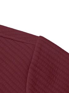 Detailed close-up of dark wine red twill knit texture and half-zip collar stitching
