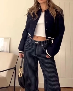 Close-up of a casual black baseball jacket and white cropped tank top outfit set
