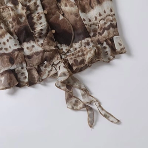 Brown tie-dye chiffon resort style top with ruffled edges and drawstring waist detail