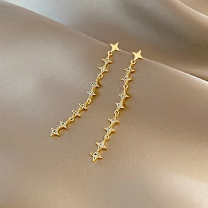 Elegant gold long drop earrings featuring star-shaped links set with zircon on silk