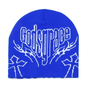 Detail of blue knitted beanie featuring white Godsgrace logo and cross pattern texture