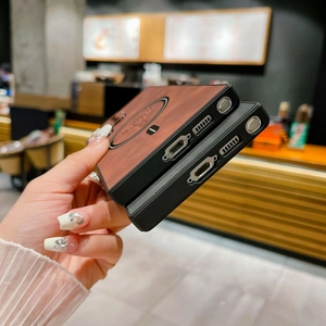 Detail view of brown leather MagSafe case and black textured phone cover with side hinge