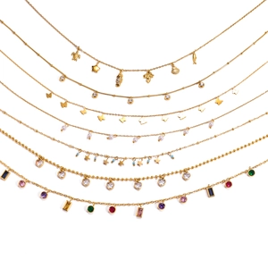 Various gold titanium steel necklaces with tropical charms, pearls and colorful crystals