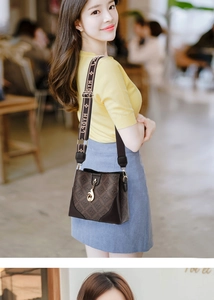 Detail of monogram patterned brown crossbody bag with HAPY strap and gold buckle