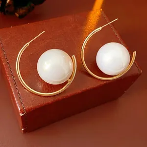 French vintage gold C-shaped hoop earrings with large white pearl on leather box