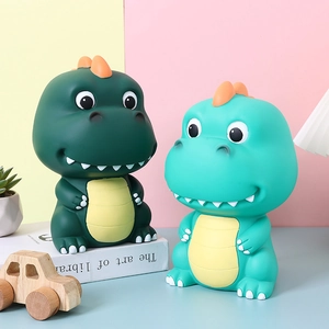 Cartoon dinosaur piggy banks in green and teal colors for kids birthday gift decor