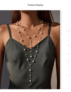 Close-up of elegant double-layer Y-shaped silver necklace with white pearls on a model