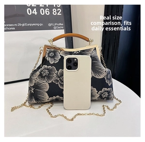 Detailed size reference of an embroidered floral satin handbag with metal chain