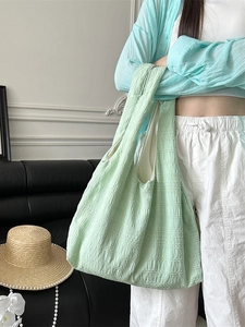 Minimalist mint green large tote bag with textured pleated fabric for daily commuting