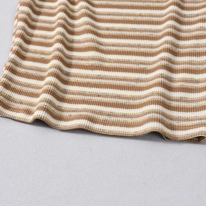 Detail of knit striped fabric in coffee and beige tones with fine needlework texture