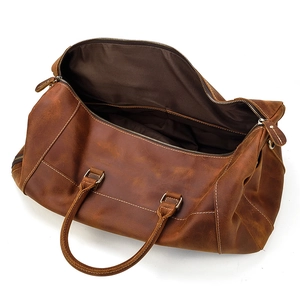 Internal view of brown leather travel bag showing spacious lining and zipper pocket