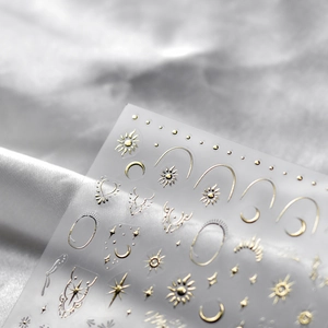 Golden 5D embossed nail art stickers with bohemian sun, moon and star totems on silk