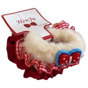 Plush red satin hair scrunchie with polka dot bow and lace trim on brand card