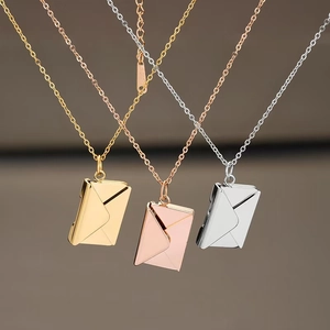 Detailed view of envelope pendant necklaces in gold, rose gold, and silver finishes
