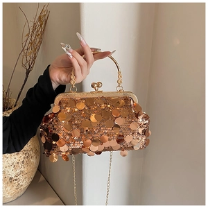 Detail of gold sequin clutch bag with metallic handle and chain strap for evening dresses