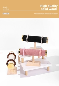 Detail view of T-bar jewelry display stand with solid wood base and velvet crossbar