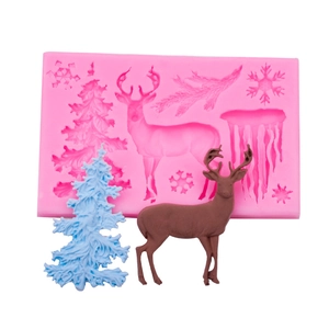 Pink Christmas silicone mold with finished tree and reindeer fondant decorations