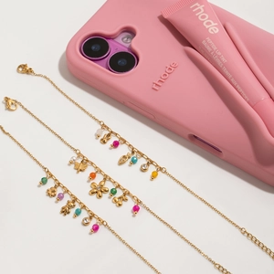Detailed close-up of 18K gold-plated necklaces with colorful charms and bear pendants