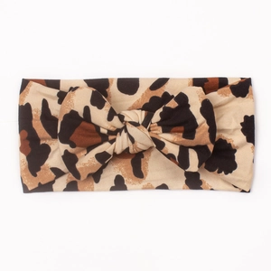 Detailed view of the leopard print baby headband featuring a large soft bow knot
