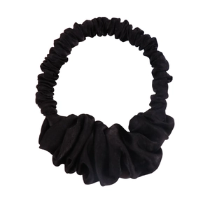 Close-up of black textured fabric hair tie for heatless waves and bun styling