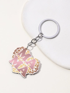 Detail of heart-shaped keychain featuring pink MAMA letters and leopard print pattern