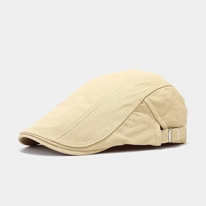 Detail of beige herringbone ivy cap showing adjustable metal side buckle and textured fabric