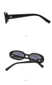 Detail view of oval sunglasses with sleek black frames and silver metallic accents