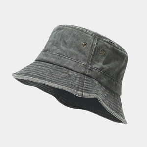 Detail view of washed cotton bucket hat with metal eyelets and vintage denim texture