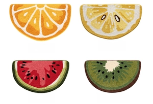 Detail of semi-circle fruit rugs featuring plush orange, lemon, watermelon, and kiwi designs