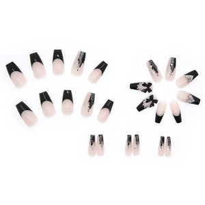 Black French tip press-on nails with 3D bows, silver glitter, and pearl heart accents