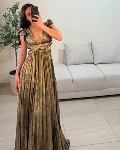 Detail of metallic gold pleated maxi dress with deep V-neck and ruffled sleeve design