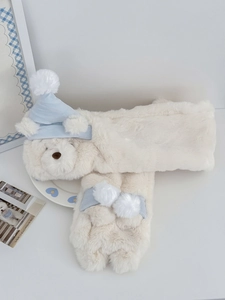 Detailed texture of soft white plush bear scarf with cute blue cap and pom-pom detail