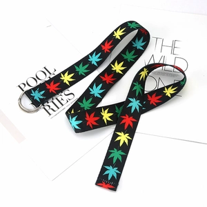 Close-up of ethnic print canvas belt with leaf pattern and silver double D-ring buckle