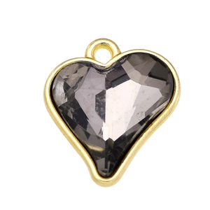 Macro detail of dark grey heart crystal pendant with gold-plated alloy frame and loop