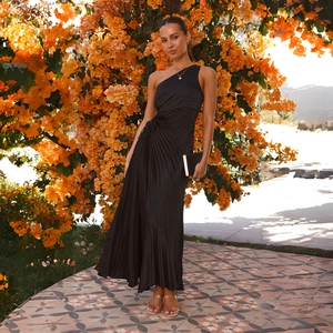 Detail of elegant black pleated one-shoulder maxi dress fabric with refined textures