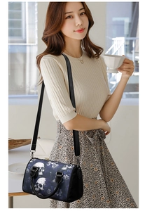 Fashion skull print boston bag shown in casual lifestyle setting with model