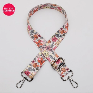Detail of floral printed bag strap with gunmetal swivel hooks and adjustable buckle