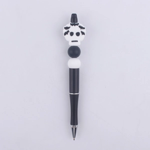Detail of Halloween beaded pen with black and white silicone beads and skull topper