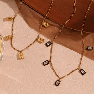 Macro detail of rectangle gold plated necklaces with zircon stones on vintage wood background