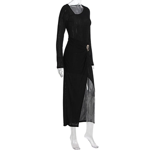 Detail of black ribbed knit dress featuring a gold buckle waist and sexy side leg slit