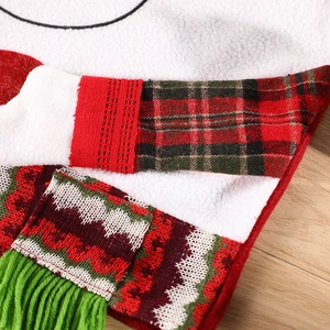 Christmas chair cover with red knit fabric, plaid patterns, and green tassels for table decor